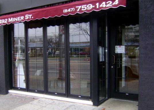 A store front with a red awning that says miner st.