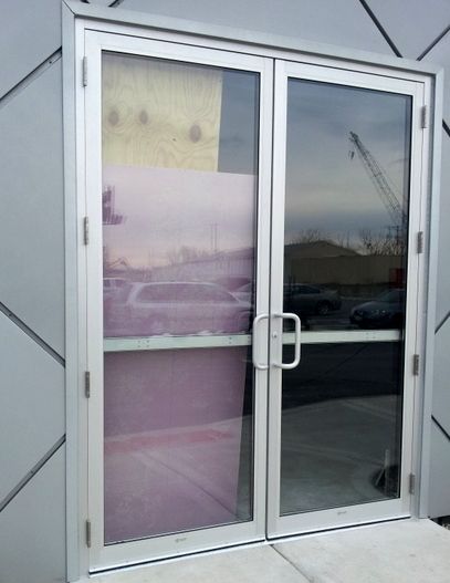 A door with a reflection of a building in it
