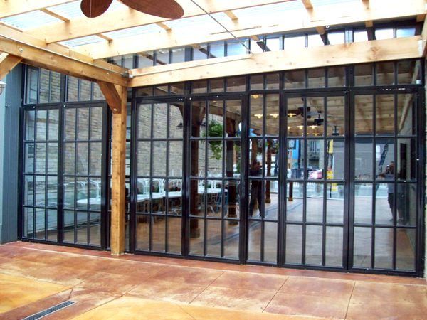 A room with a lot of windows and a ceiling fan