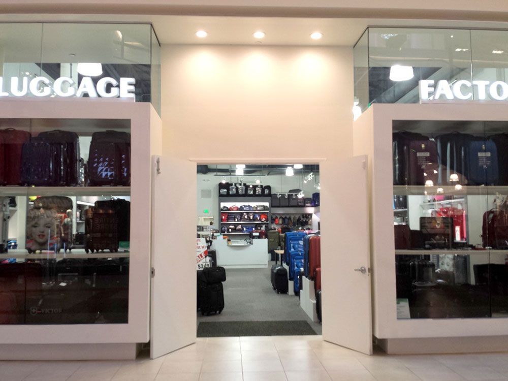 A luggage factory store with a lot of luggage on display