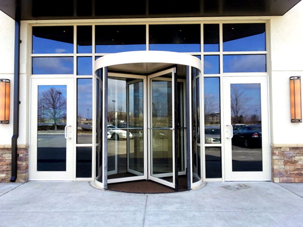A building with a revolving door and a lot of windows