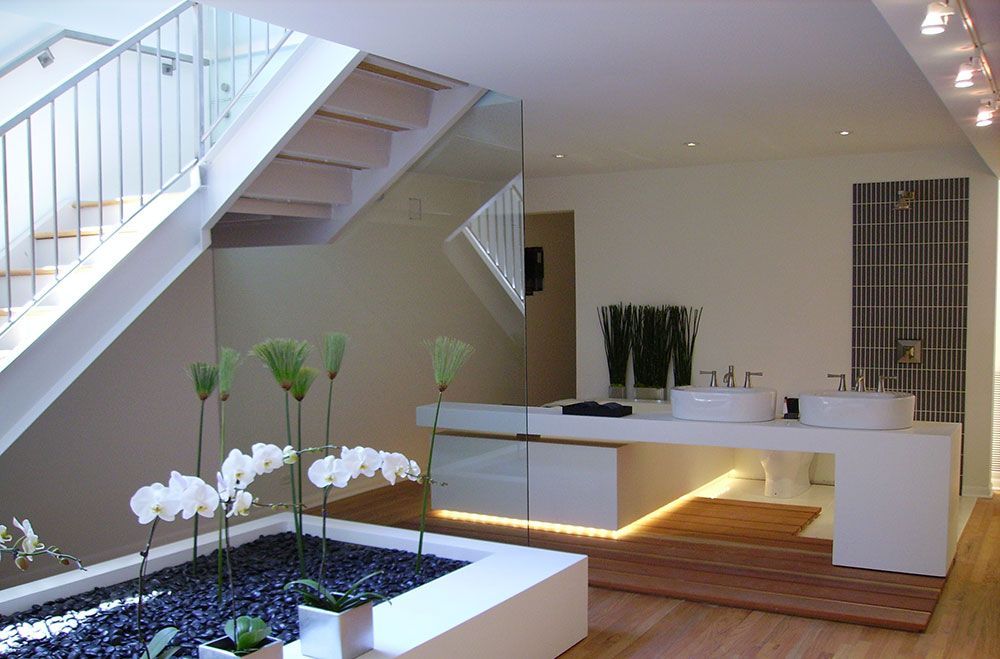 A bathroom with two sinks and a staircase in the background