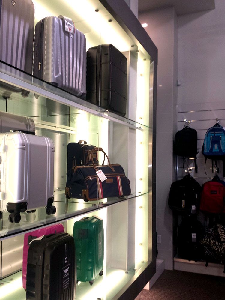 A bunch of suitcases are on display in a store