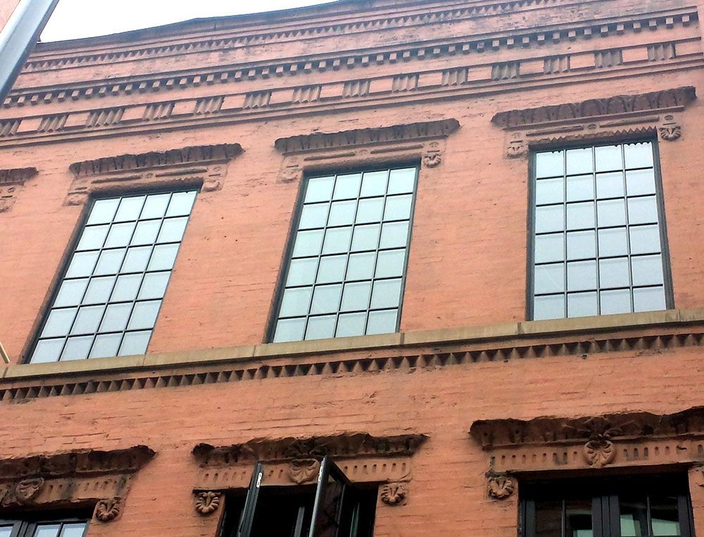 A brick building with a lot of windows on it