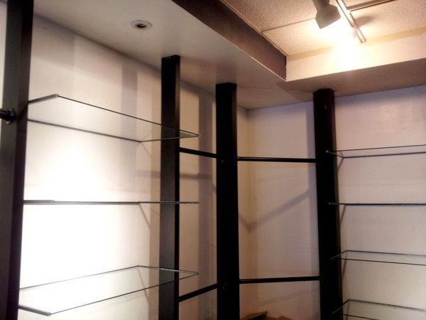 A room with shelves and a light on the ceiling