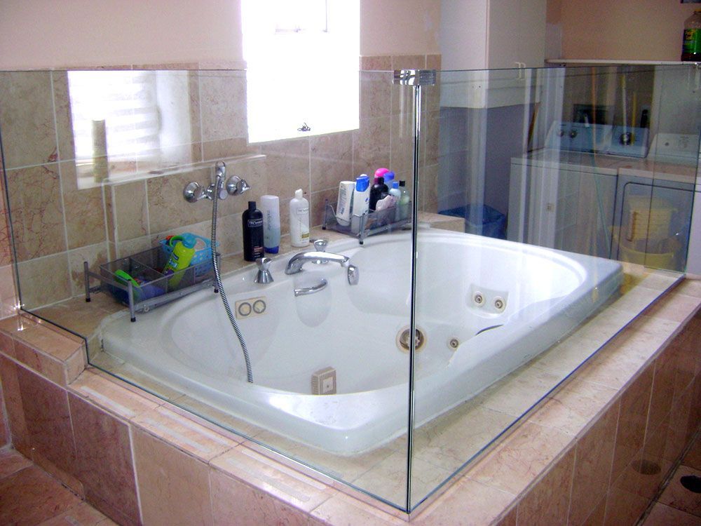 A bathroom with a jacuzzi tub surrounded by glass.