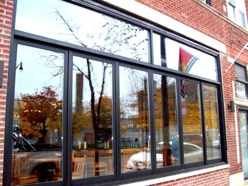 A large window on a brick building with lots of windows