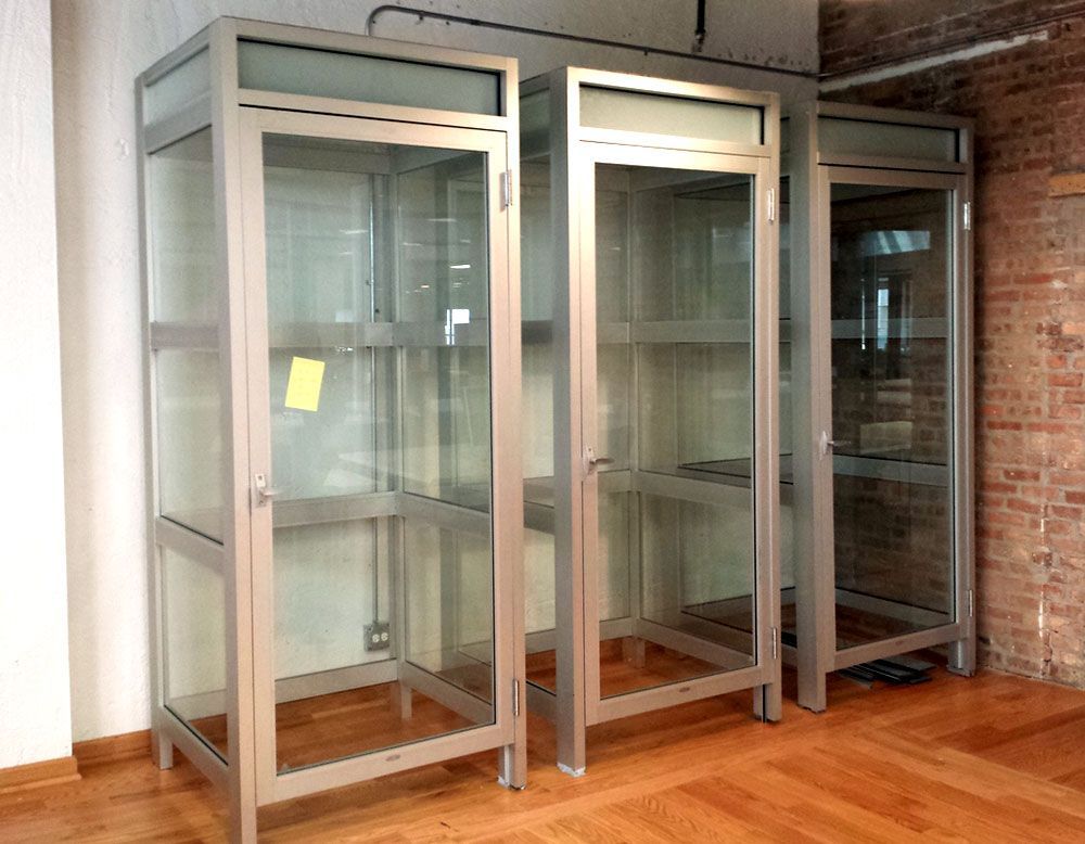 A room with a lot of glass doors and a brick wall.