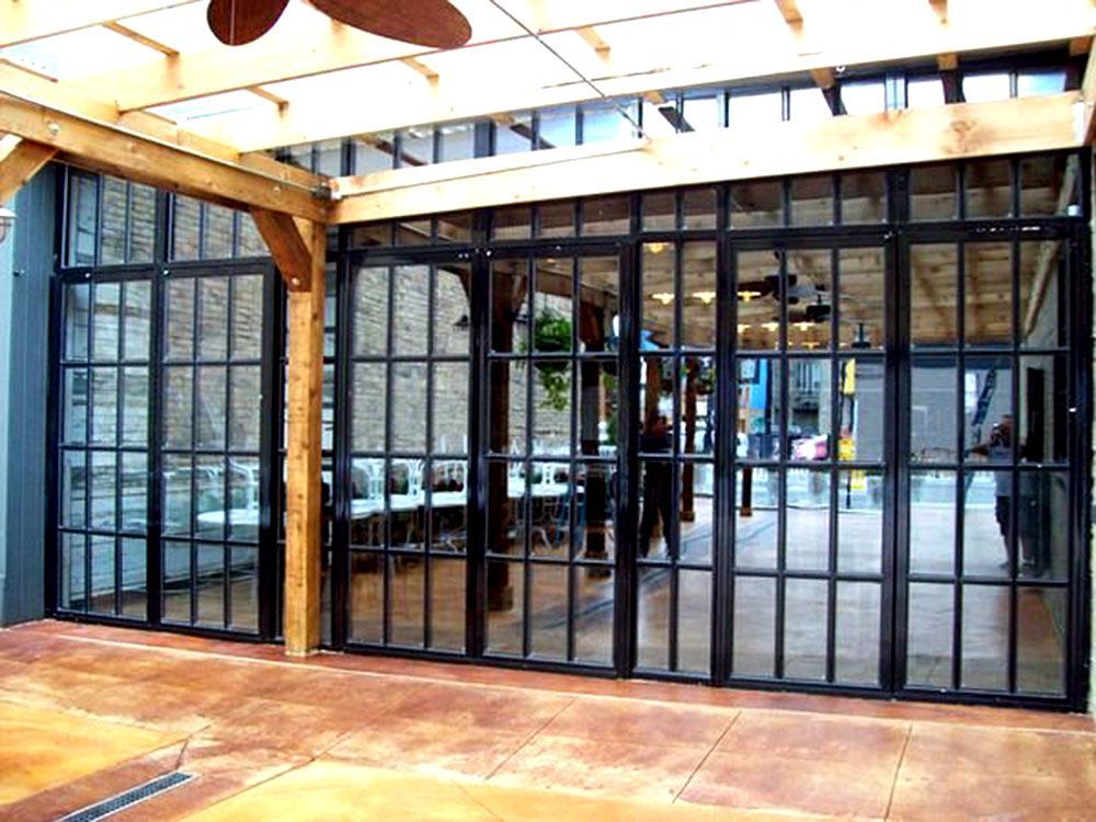 A room with a lot of windows and a ceiling fan