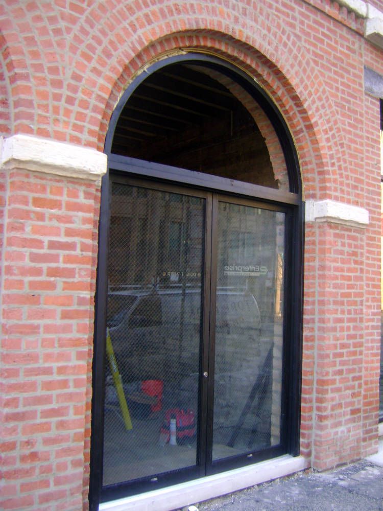 A brick building with a sliding glass door