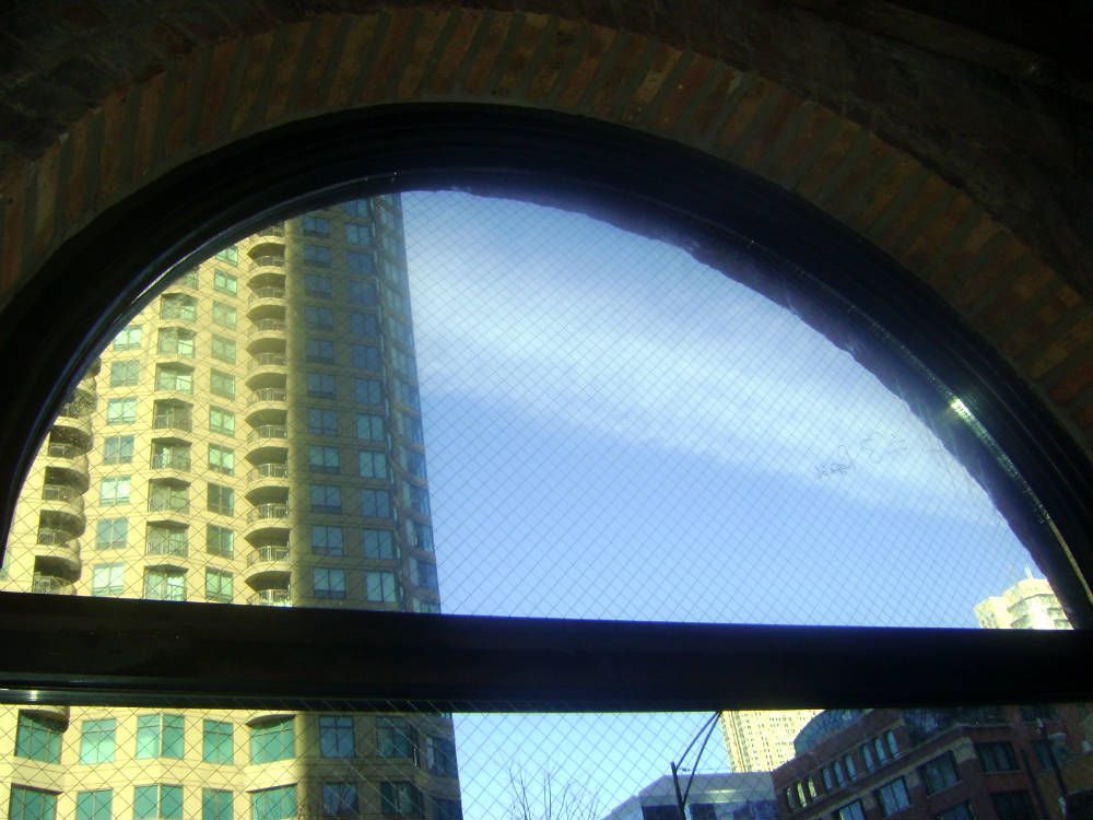A large building is reflected in the window of a building