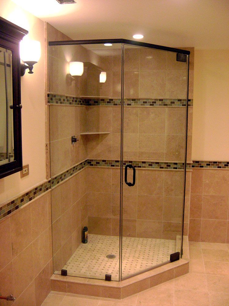 A bathroom with a walk in shower and a mirror