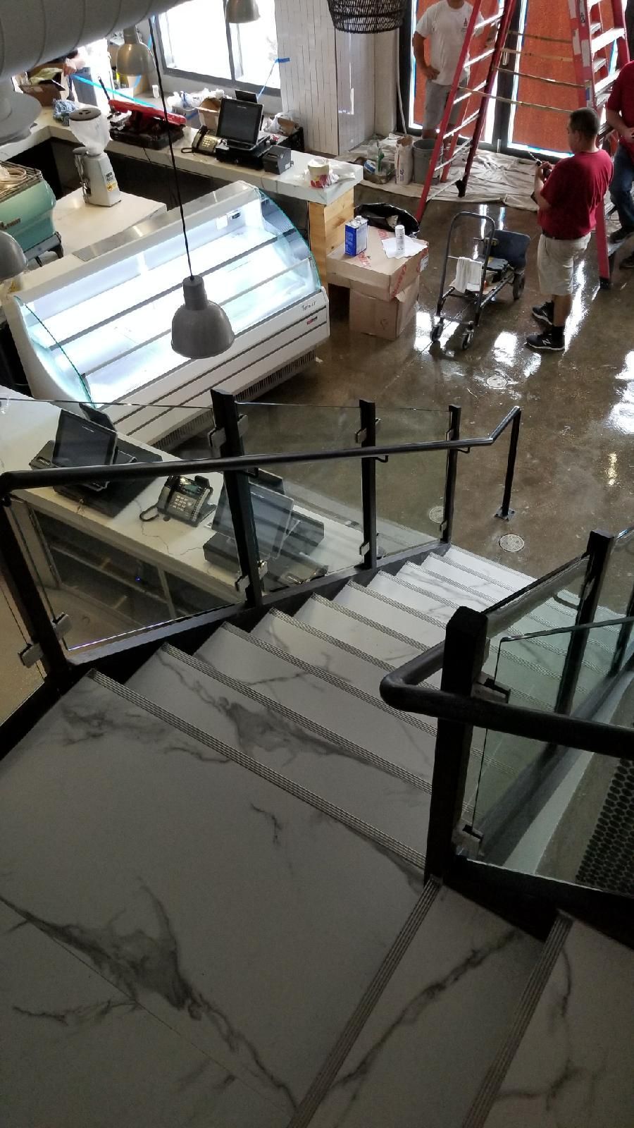 A view of a restaurant from the top of the stairs.