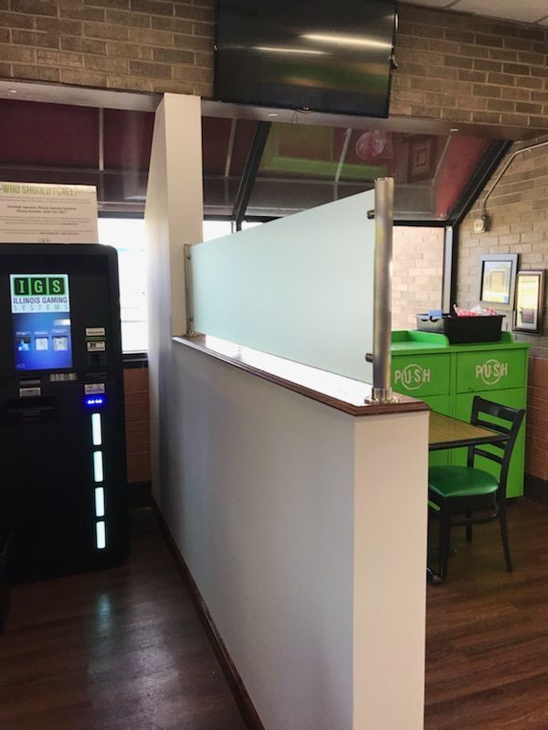 A subway restaurant with a table and chairs and a vending machine