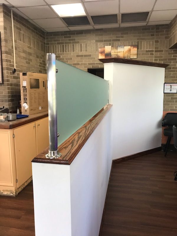 A room with a brick wall and a glass divider