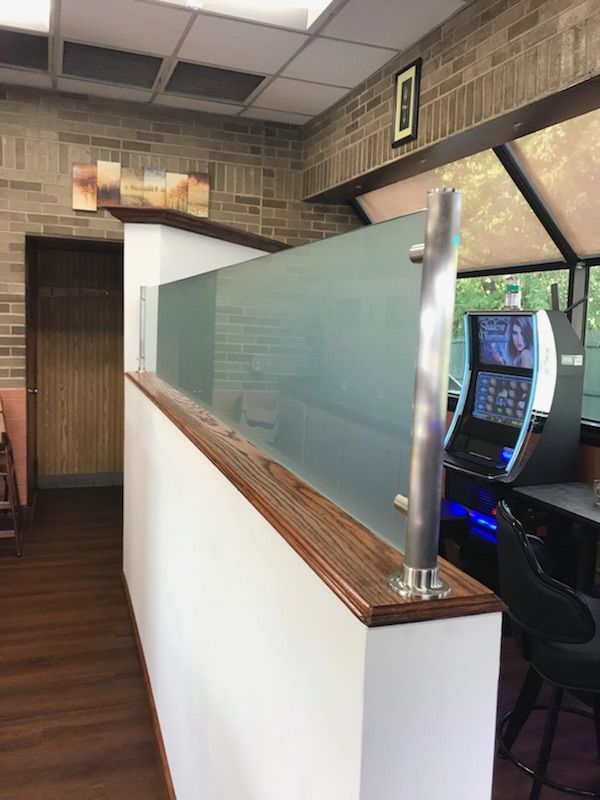 A room with a brick wall and a slot machine