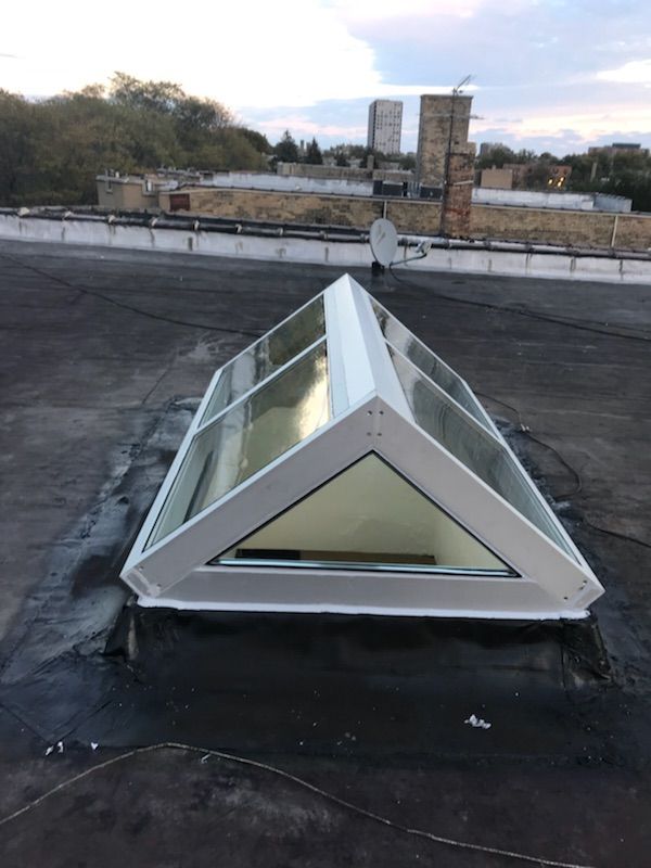 A triangle shaped skylight on the roof of a building