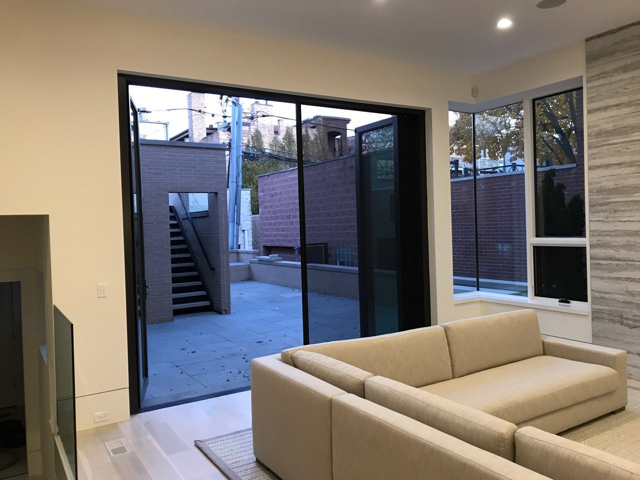 A living room with a couch and sliding glass doors