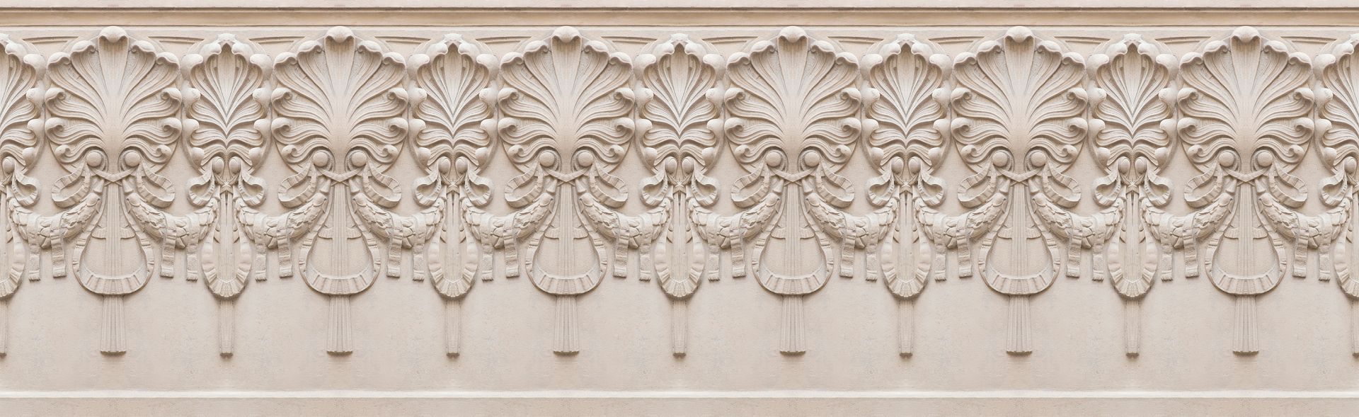A detailed, light-colored architectural frieze with ornate floral and scrollwork patterns.