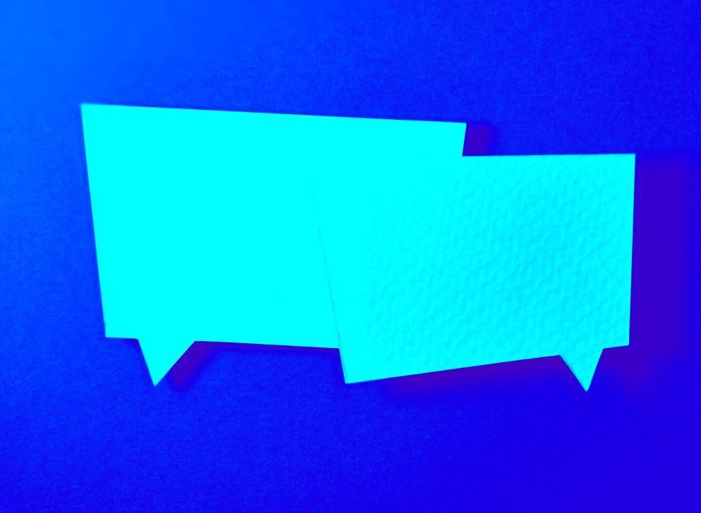 Two blue speech bubbles are floating in the air on a blue background.