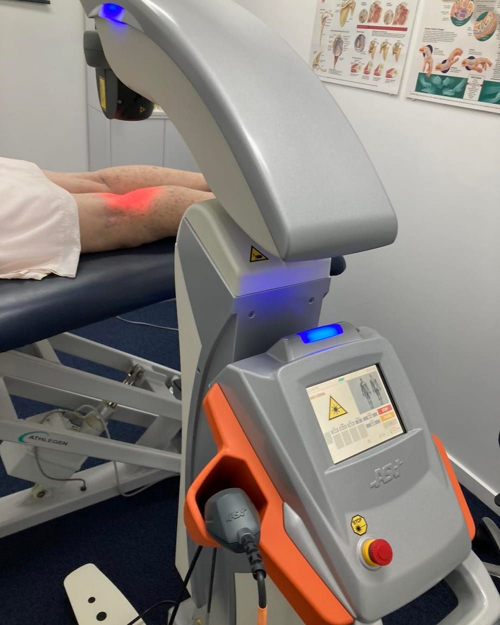 A Person is Laying on a Bed With a Machine on It — Sugarland Chiropractic Centre in Avoca, QLD