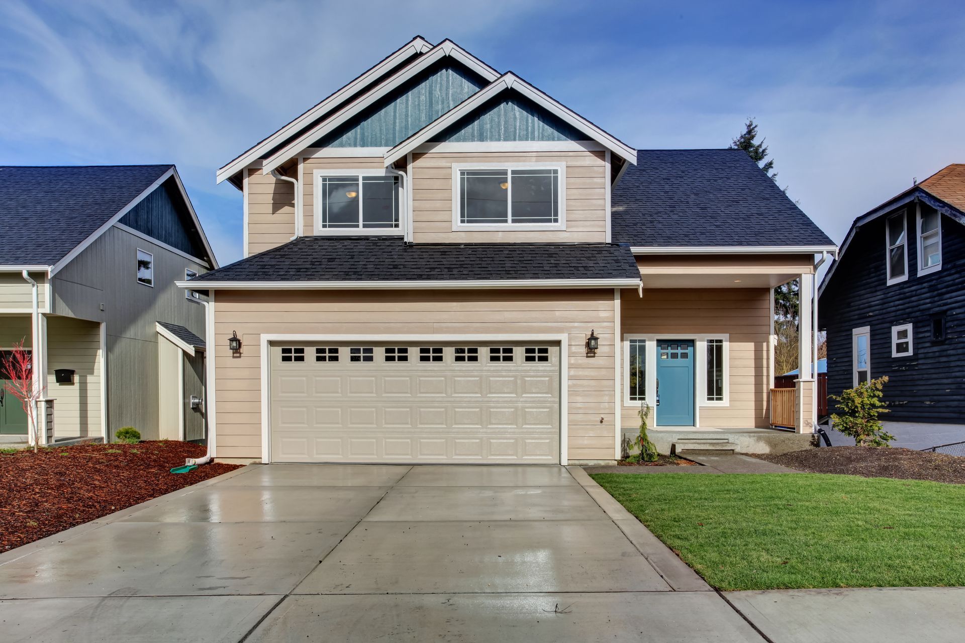 A house with a large garage and a blue door