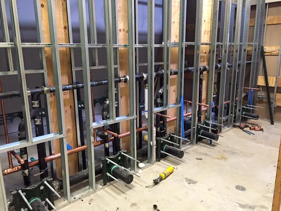 Calhoun Plumbing Services LLC | A room with a lot of pipes hanging from the walls.