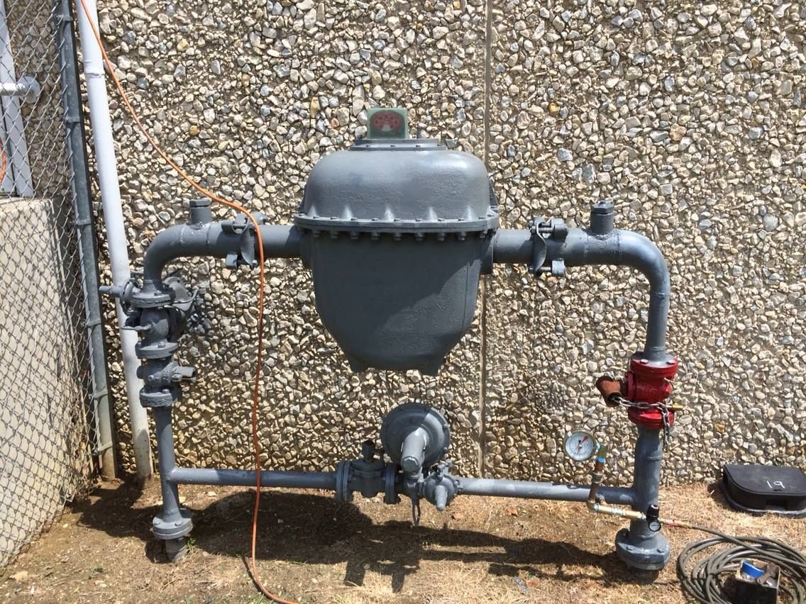 Calhoun Plumbing Services LLC | A gray pipe is sitting in front of a stone wall