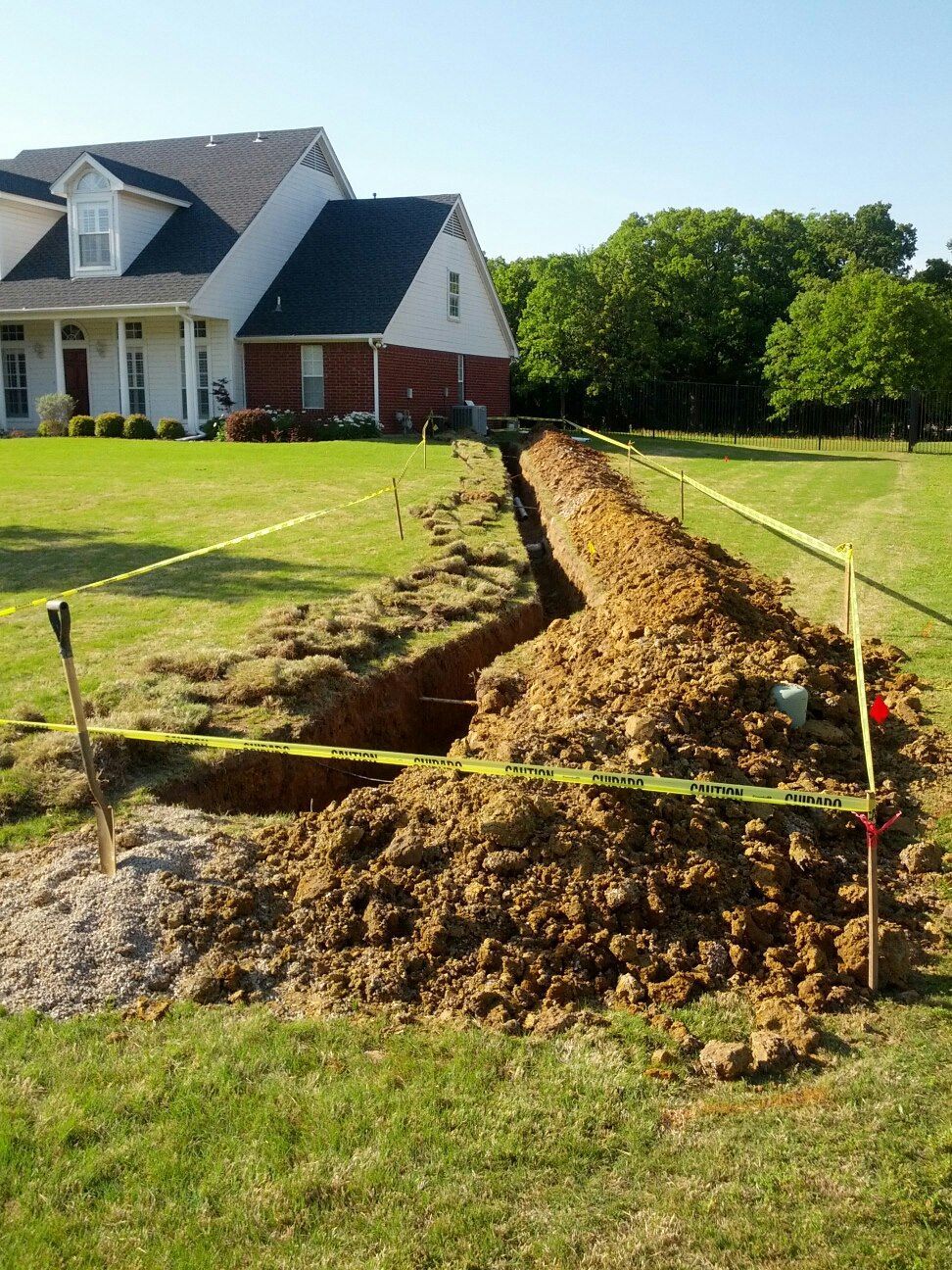 Calhoun Plumbing Services LLC | A large pile of dirt is in front of a house