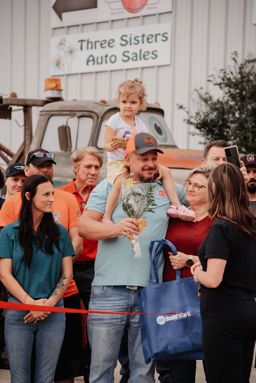 Man standing with a little girl on top of him. | Chuck's Garage