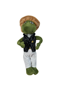 Stuffed frog wearing a hat, vest, and pants; arms on hips.