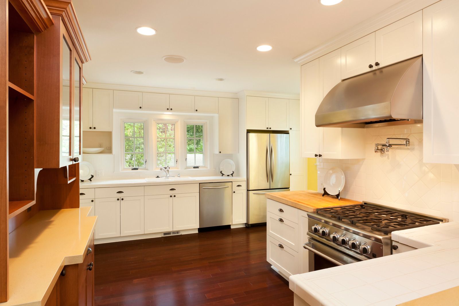 A kitchen with white cabinets and stainless steel appliances