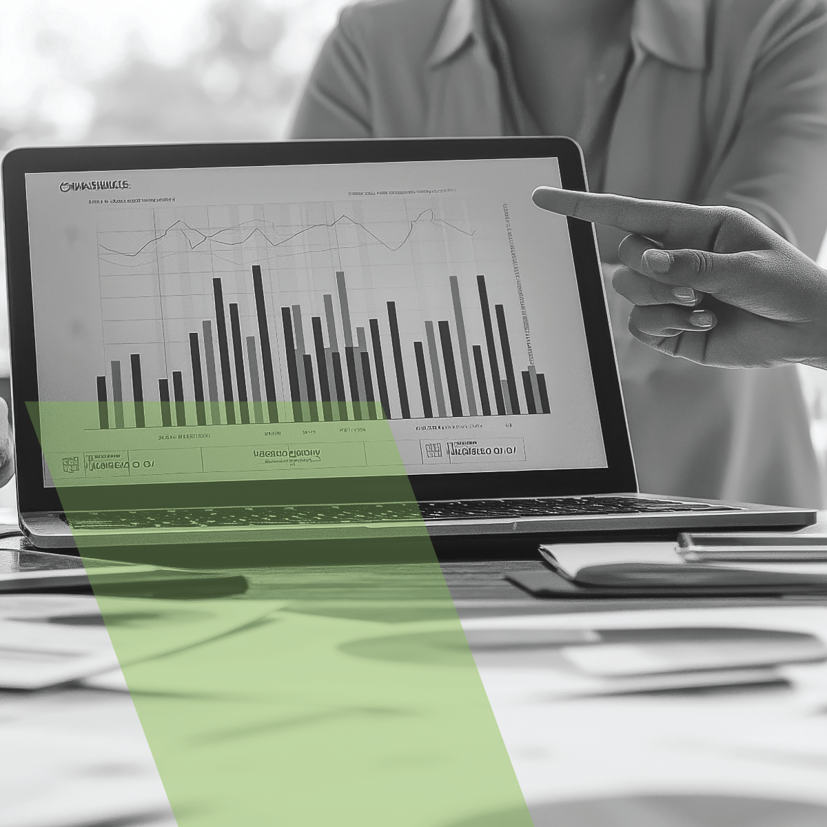 A person is pointing at a graph on a laptop screen.