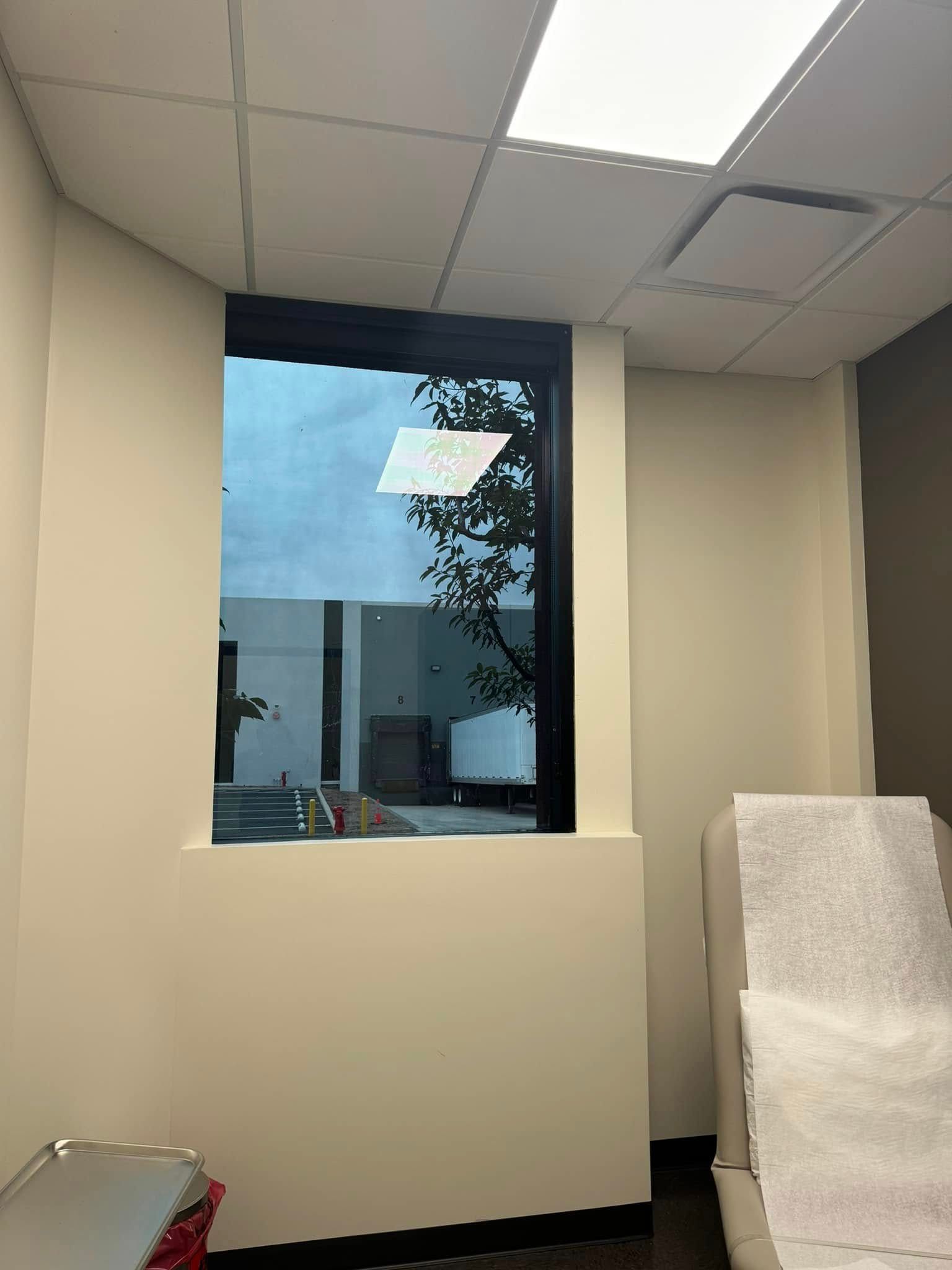 A room with a window and a couch in it.