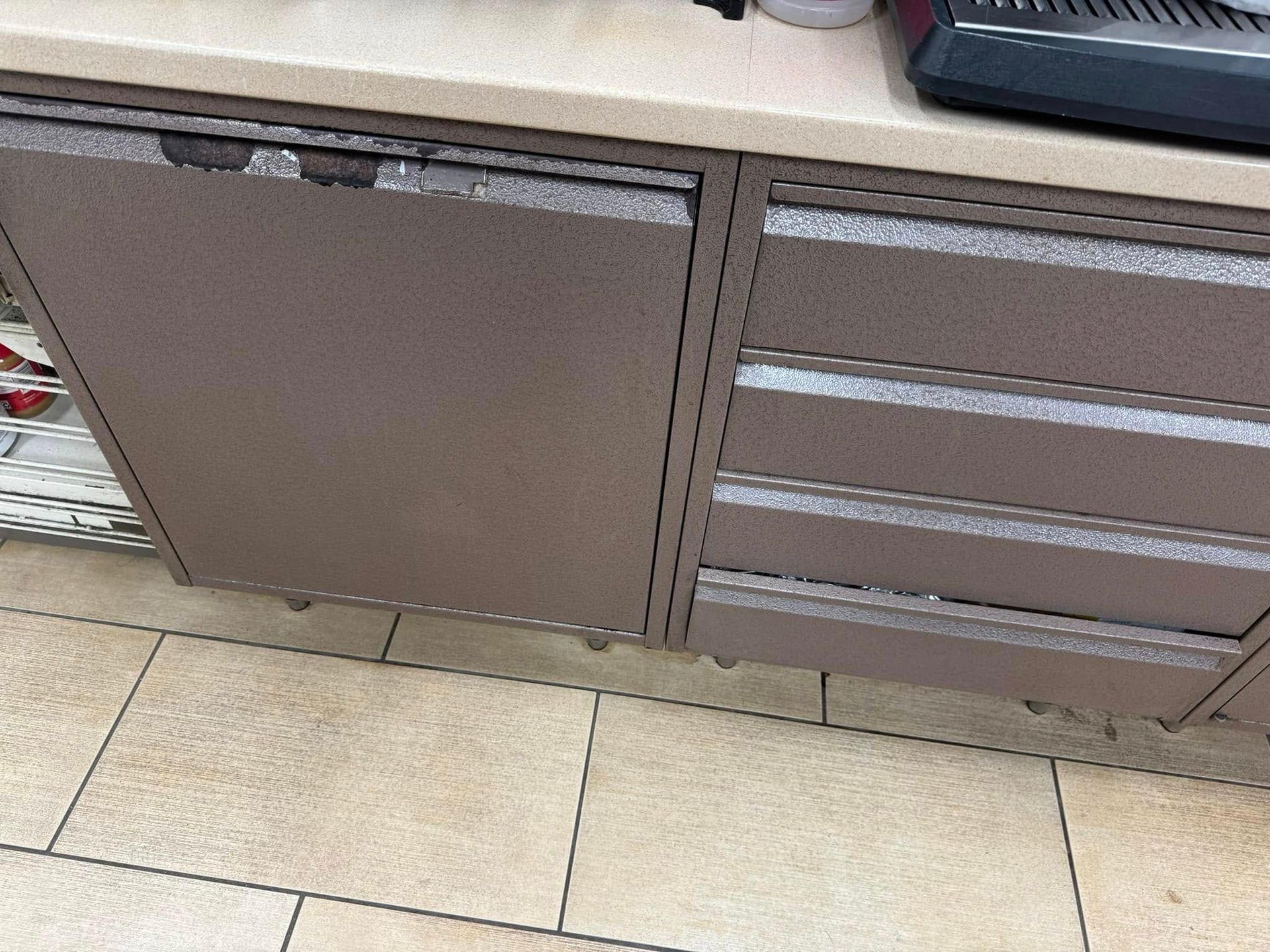 A close up of a cabinet with drawers in a kitchen.