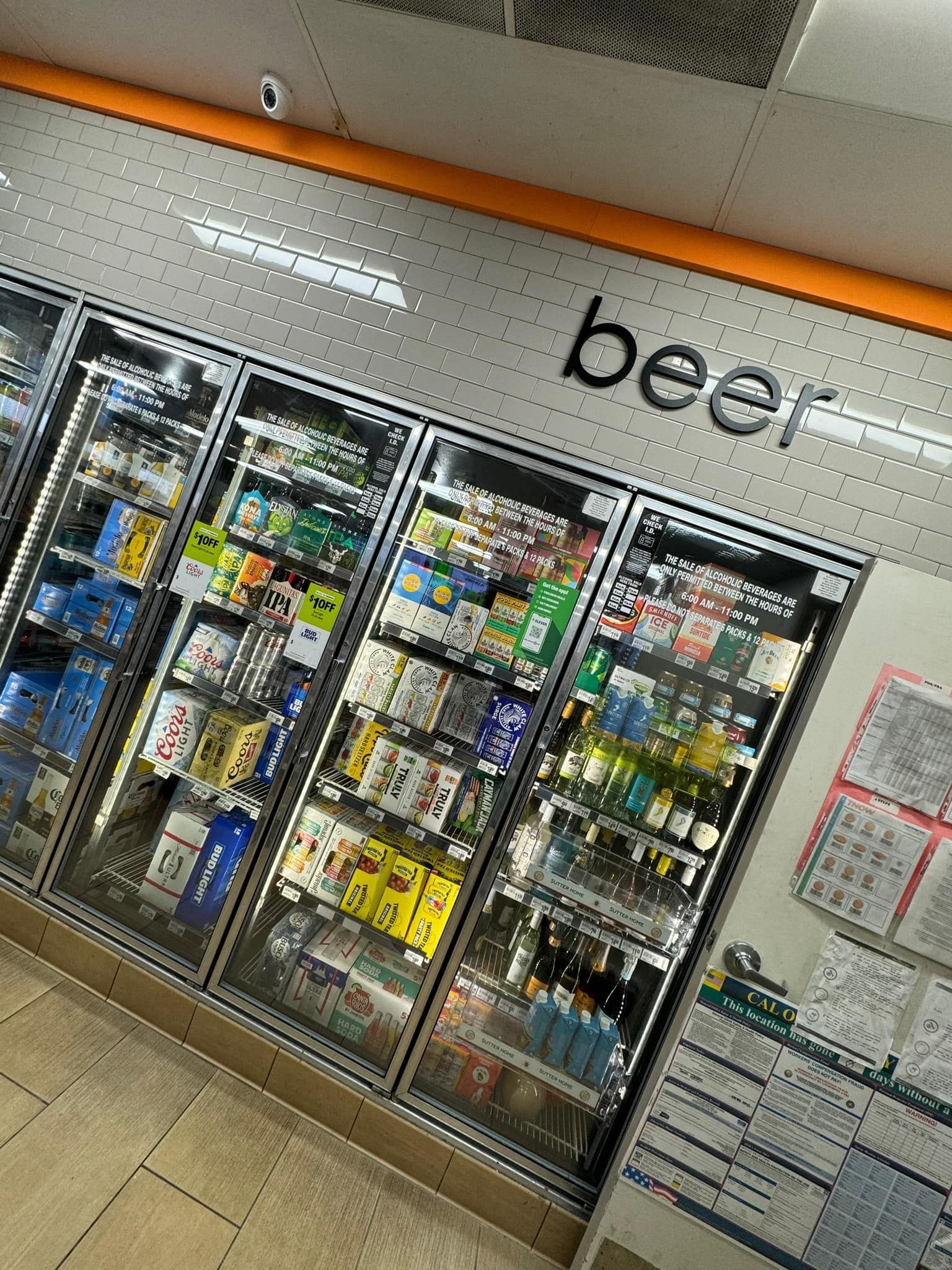 A refrigerator filled with lots of beer in a store.