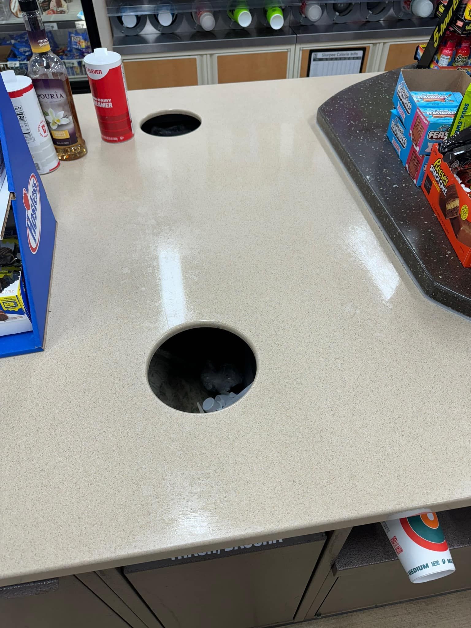 A counter at a gas station with two holes in it.