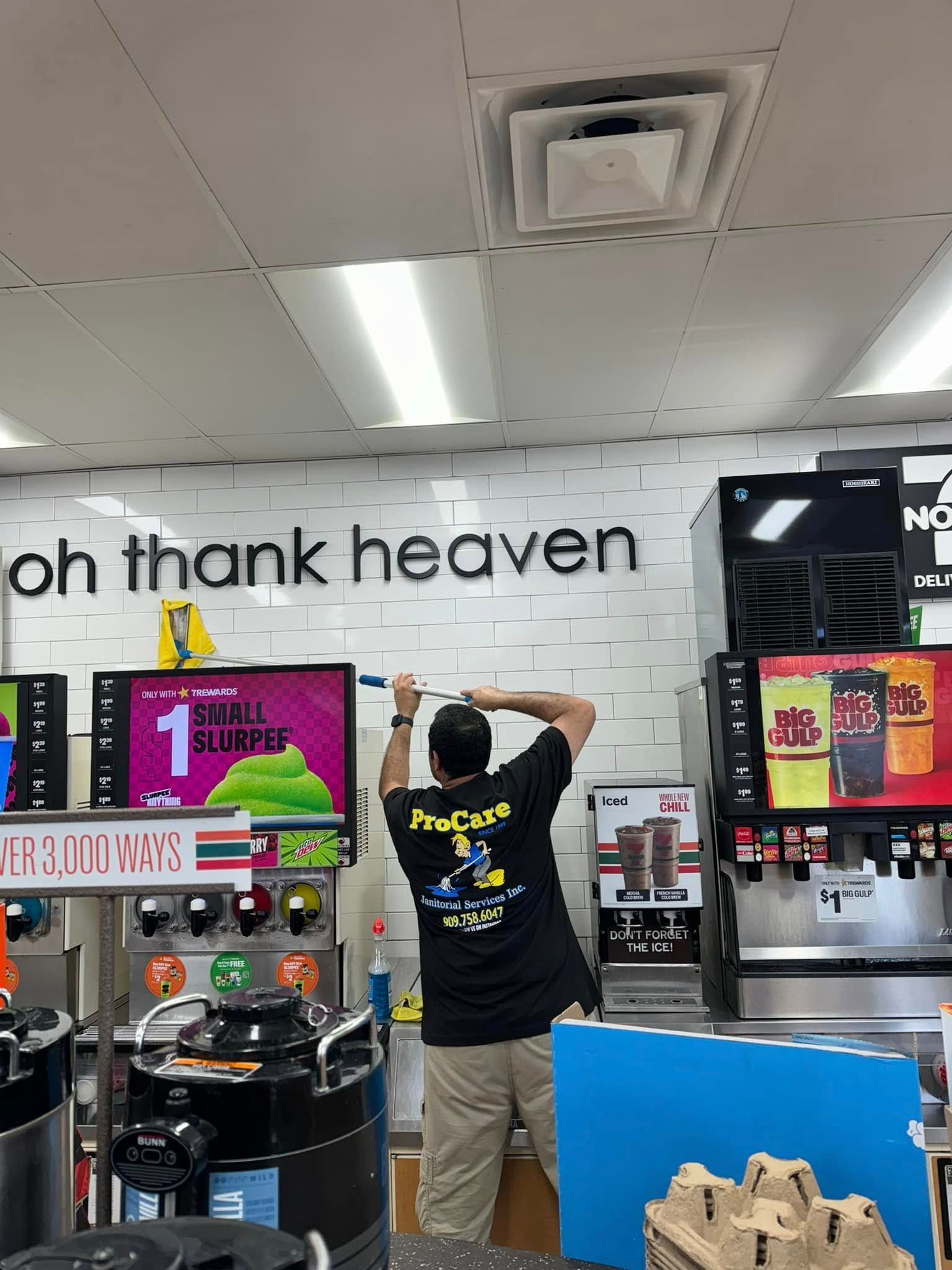 A man is standing in front of a sign that says `` oh thank heaven ''.