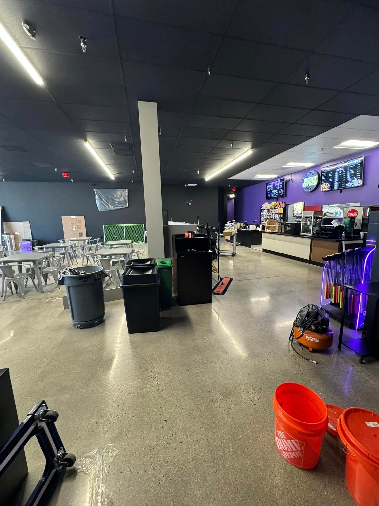 A large room with a lot of trash cans and buckets in it.