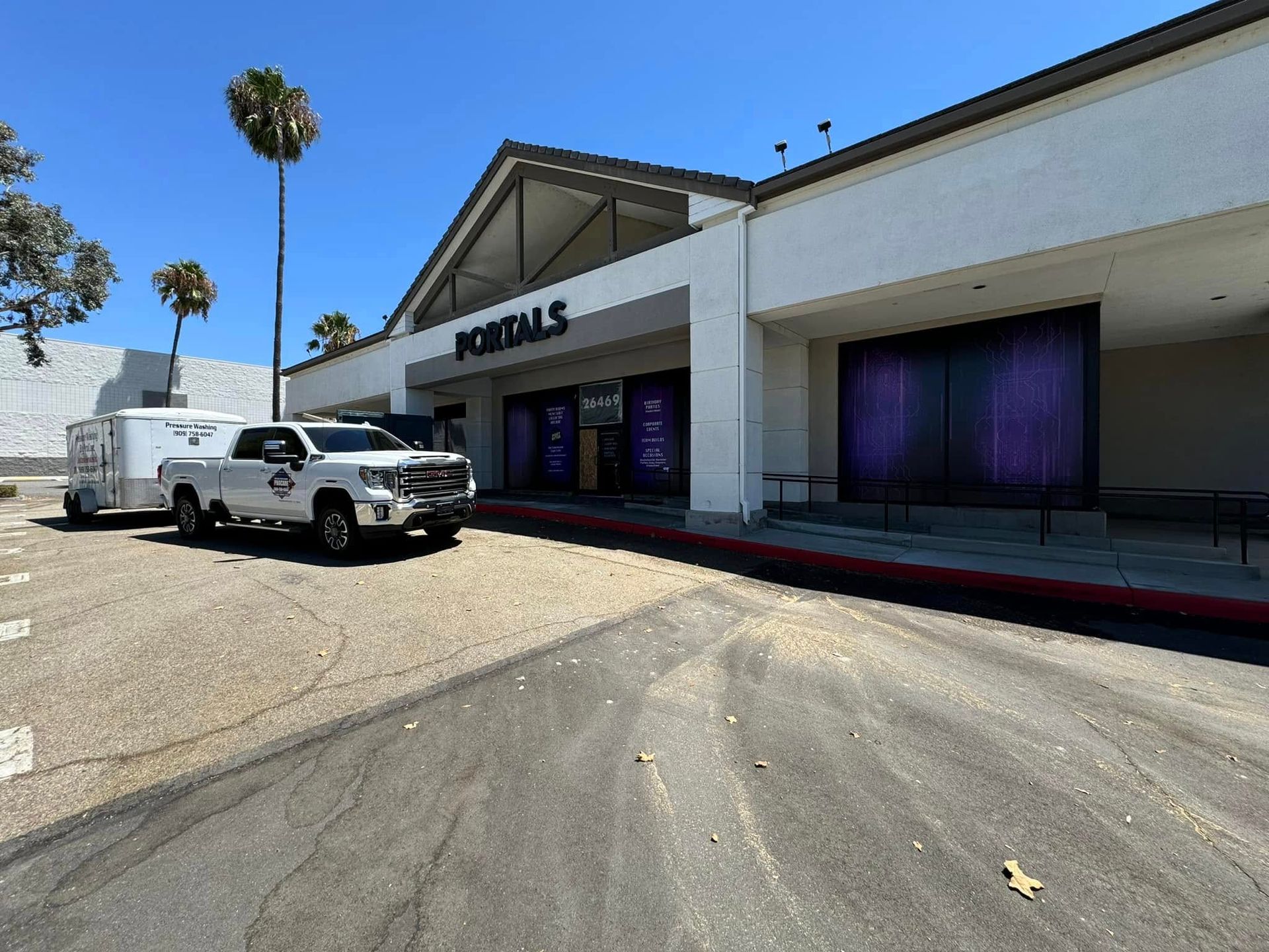A white truck is parked in front of a building.