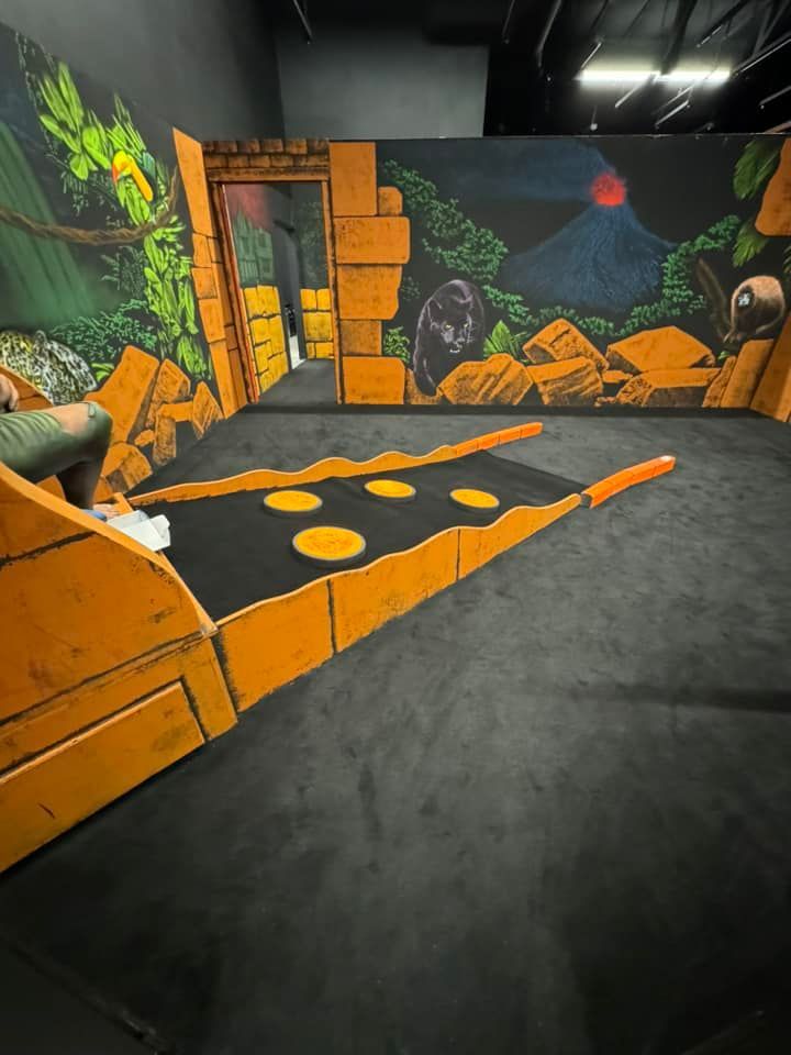 A person is sitting in a room with a painting on the wall.