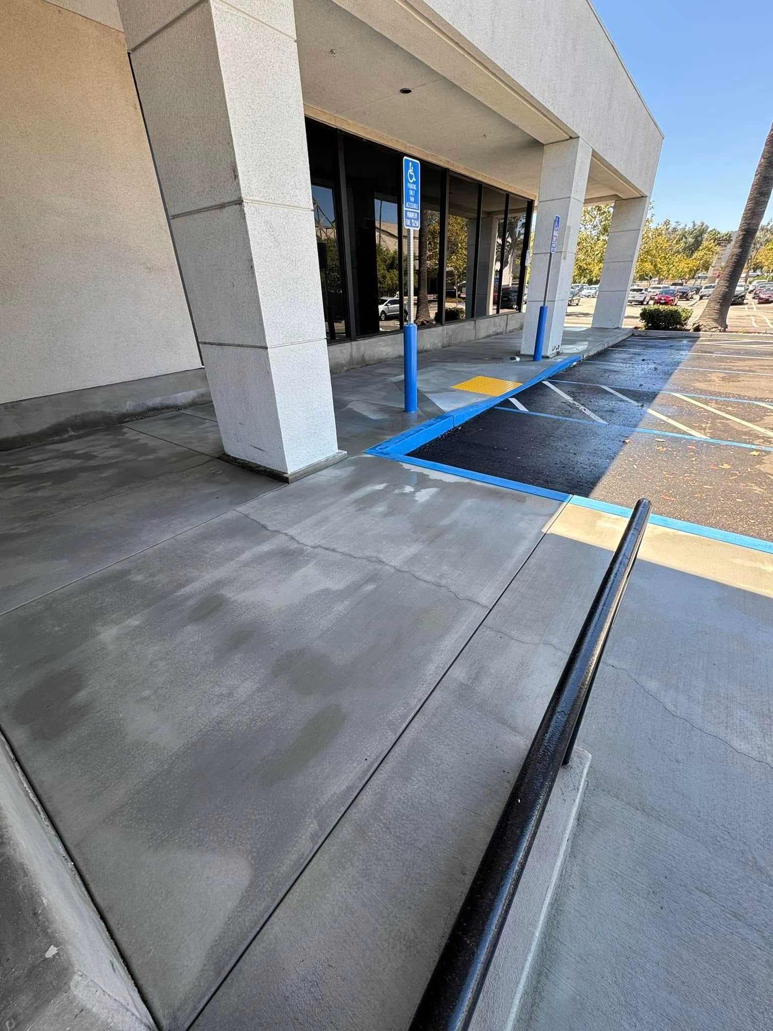 A parking lot with a handicapped parking spot in front of a building.