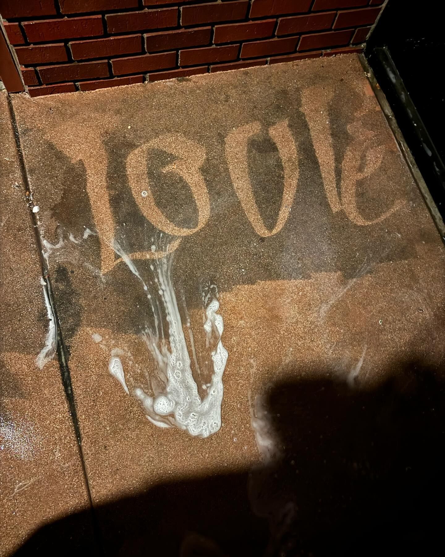 A brick wall with the word love written on it