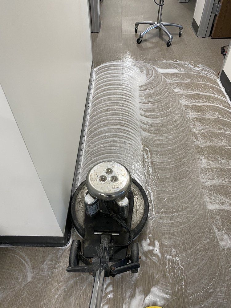 A vacuum cleaner is cleaning the floor of a room.