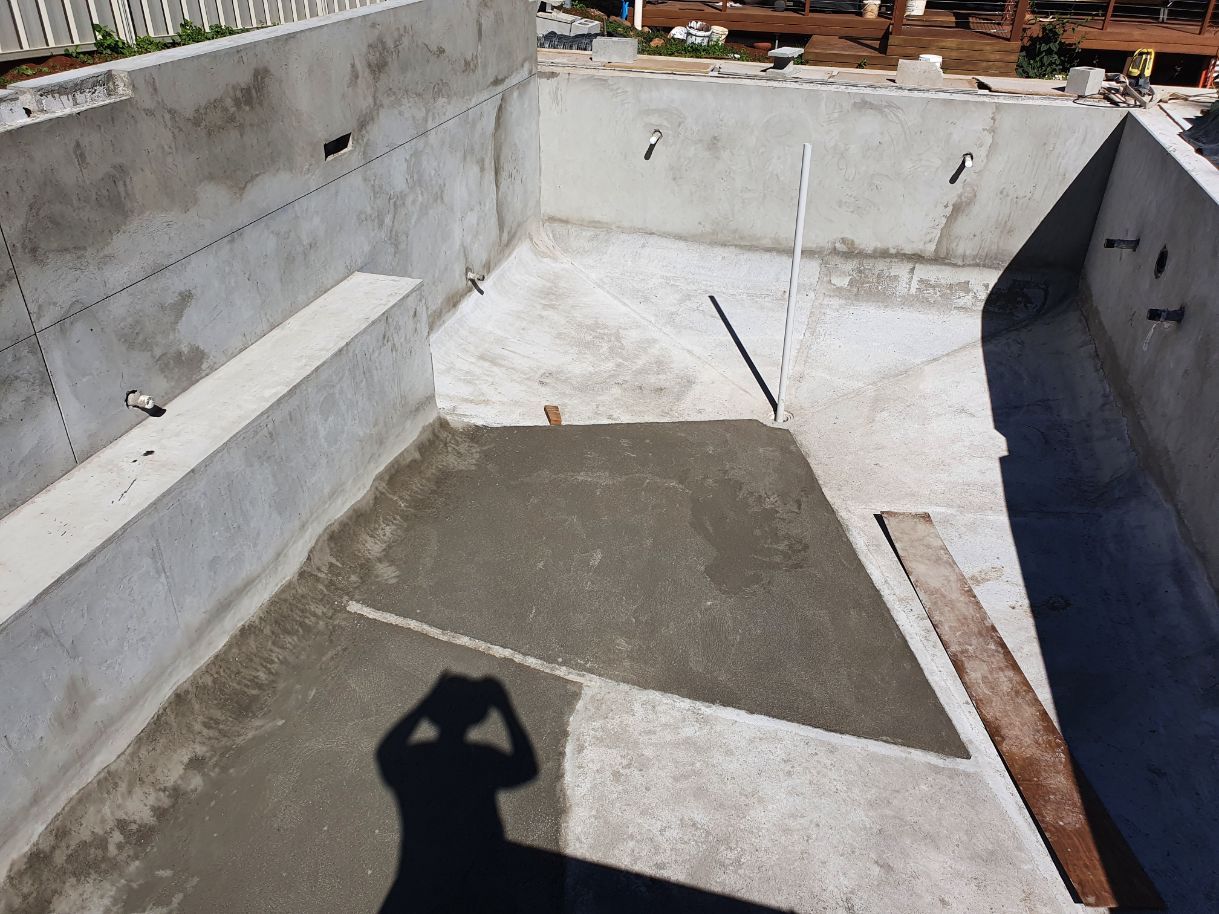 A Shadow of a Person is Cast on a Concrete Surface — Brett Rayner Cement Rendering In Lismore, NSW