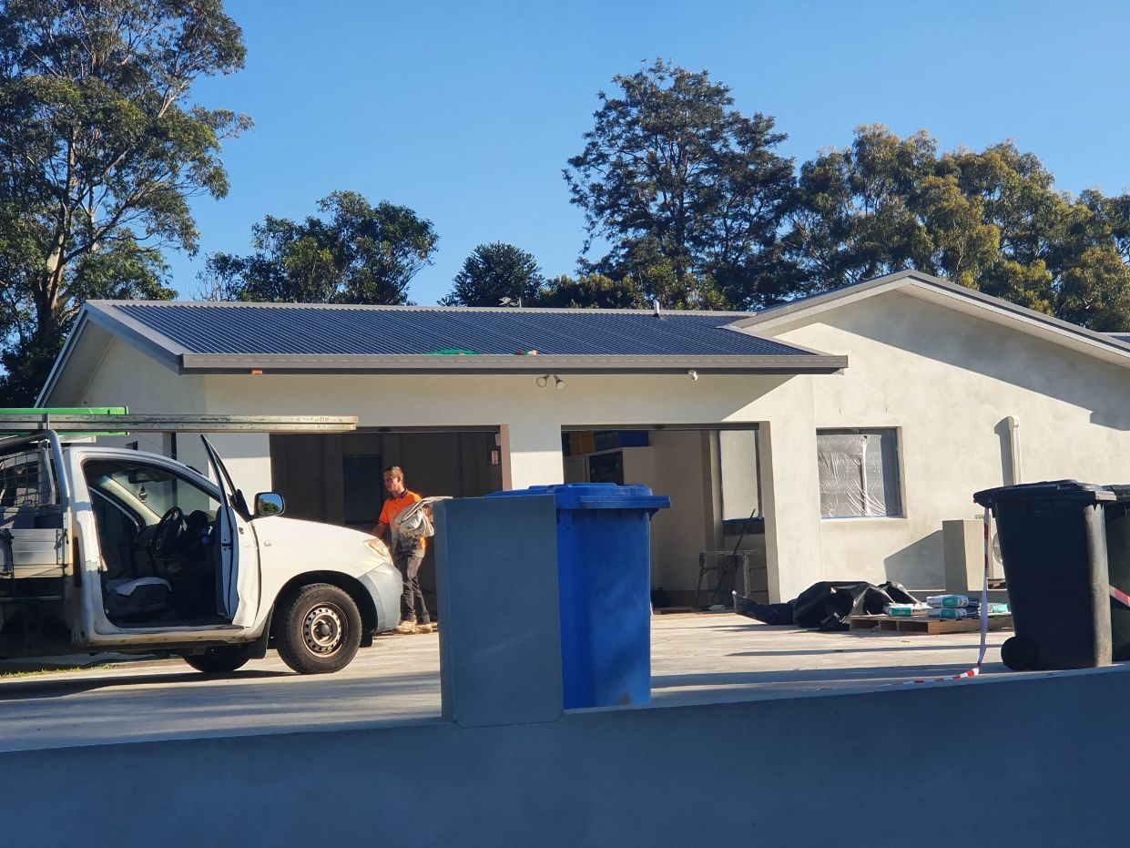 A White Truck is Parked in Front of a House — Brett Rayner Cement Rendering In Goonellabah, NSW