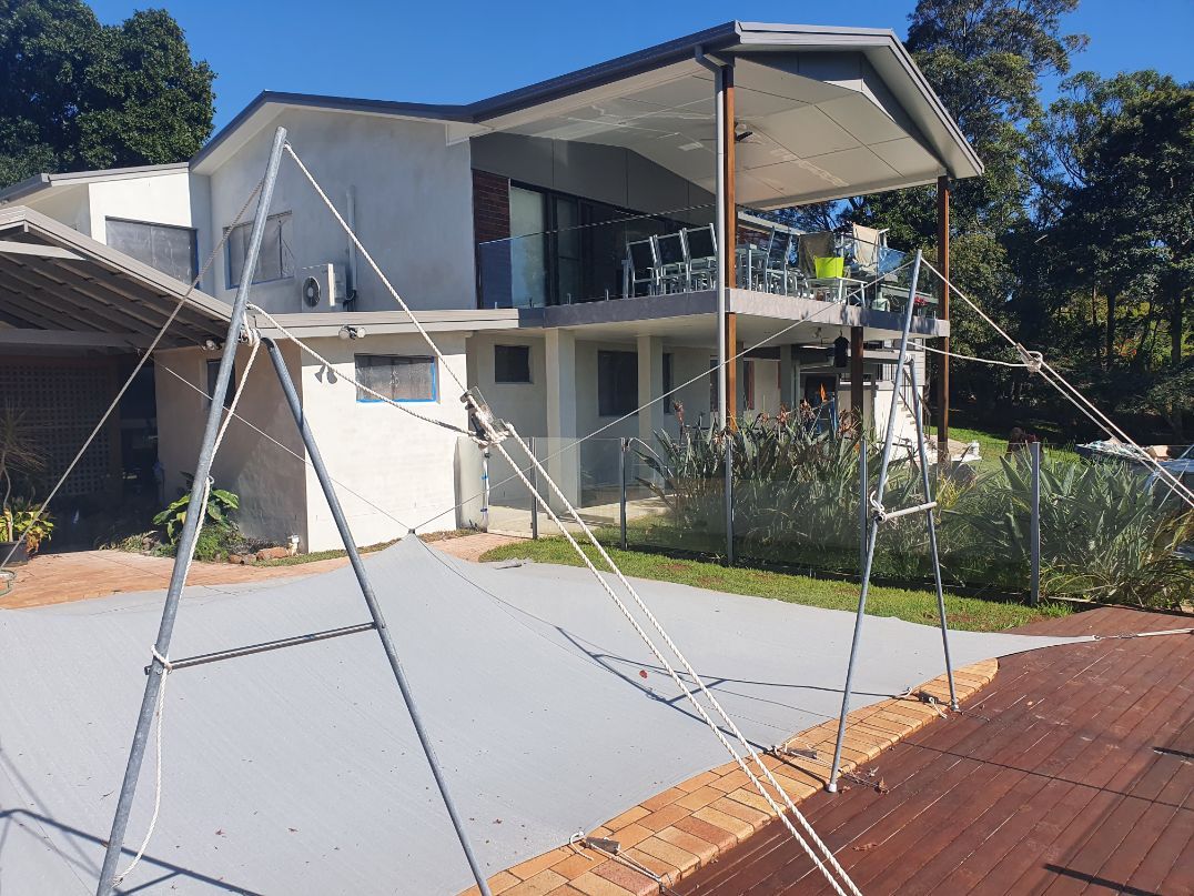 A House With a Broken Fence in Front of It — Brett Rayner Cement Rendering In Goonellabah, NSW