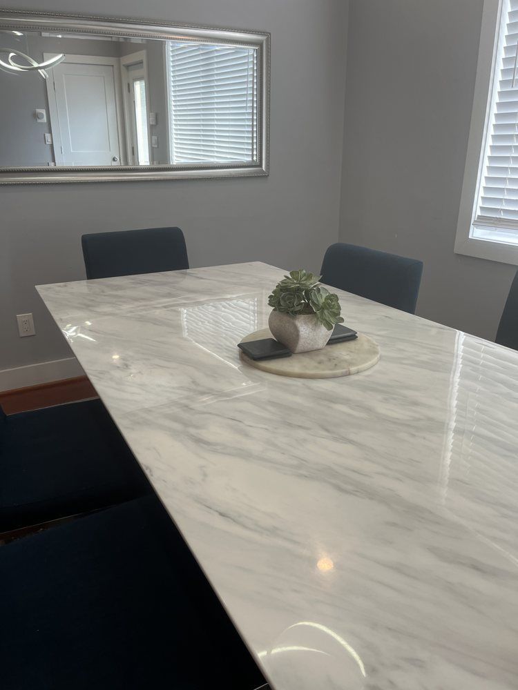 There is a plant on the table in the dining room.