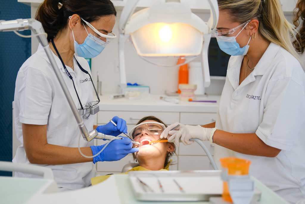 Female dentists treating a patient