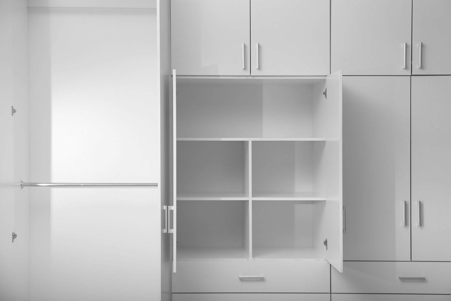 White empty closet with open doors and shelves.